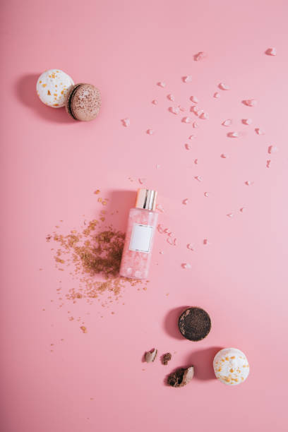 istock Creative flat lay top view bottle mock up with cookies on pastel millennial pink paper background copy space. Template for text lettering blogging 1167433487