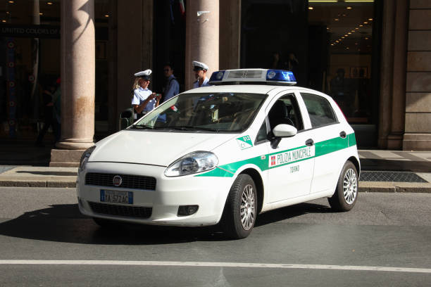 Fiat Grande Punto municipal police car on the street Turin, Italy - 22 September, 2011: Fiat Grande Punto municipal police car on the street. This vehicle is used to patrols on the streets. punto stock pictures, royalty-free photos & images