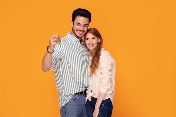 istock Happy couple with keys to new home. 1167438074