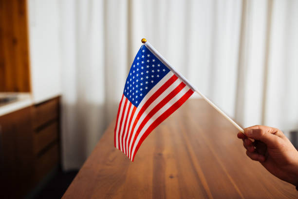 istock USA Flag in Human Hand Indoors 1167438331