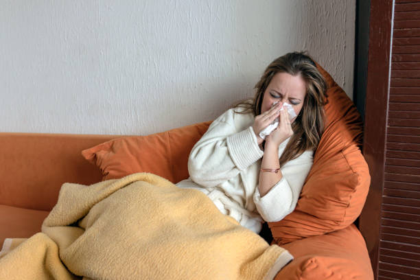 istock Woman with Allergic Cold is Blowing Nose at Home 1167439143