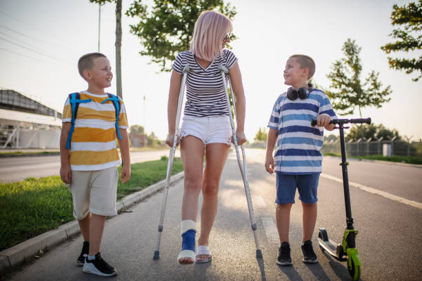 istock Mother with her sons walking using crutches 1167439610