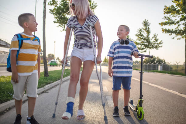 istock Mother with her sons walking using crutches 1167439615