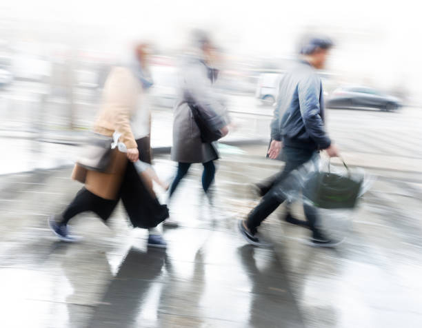 istock Pedople rushing over pedestrian crossing on rainy day 1167442851