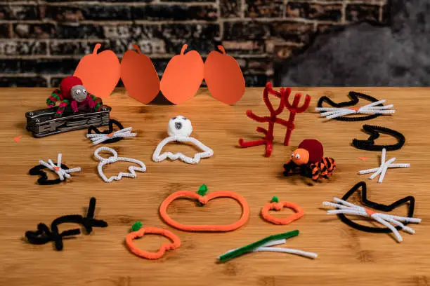 Halloween pipe-cleaner and construction paper crafts featuring Black Cats, pumpkins, ghosts, spiders and the devil.