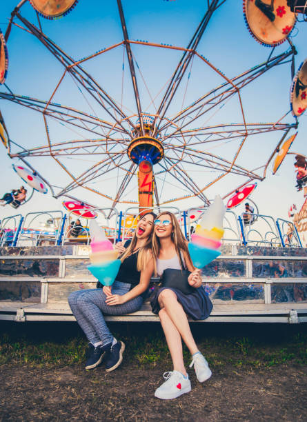 istock Happy sisters at amusement park 1167449096