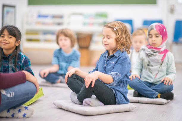 Group of elementary students Diverse group of lower elementary students in the classroom. mindfulness kids stock pictures, royalty-free photos & images