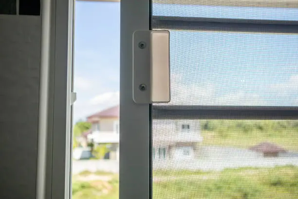 Photo of Open mosquito net wire screen on house window protection against insect