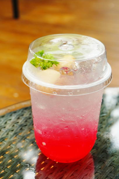 Cool red soda water in plastic glass