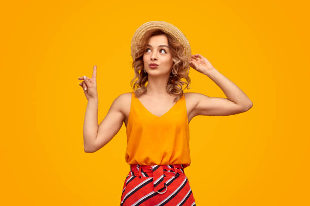 istock Flirty young woman pointing up 1167454921