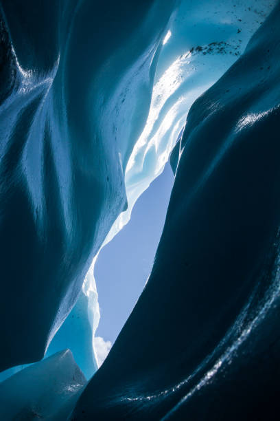 istock Skylight from within an ice cave looking up at the sky. 1167459168