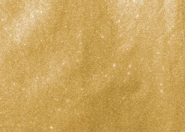 Gold glitter texture sparkling shiny wrapping paper background for Christmas holiday seasonal wallpaper decoration, greeting and wedding invitation card design element stock photo