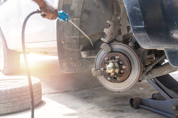 istock Mechanic use air gun clean disc break take dust removes before change break pat. 1167462156