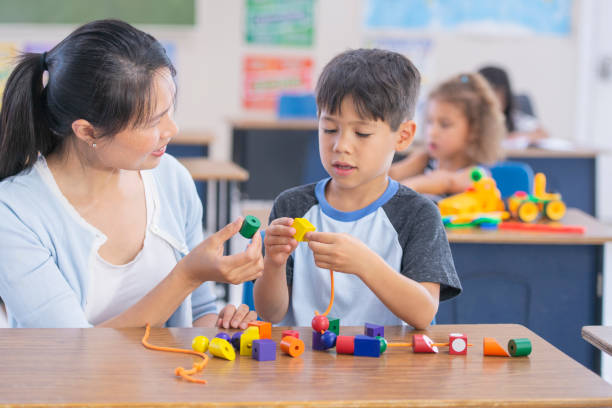istock Young Asian Teacher Helps Her Male Student 1167464368