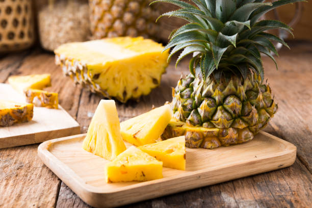 istock pineapple on the wood  background 1167467791