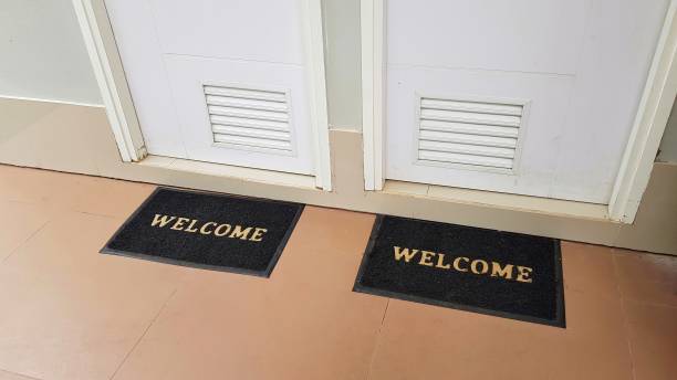 istock Two doormats lying in front of two doors with welcome written on it 1167471362