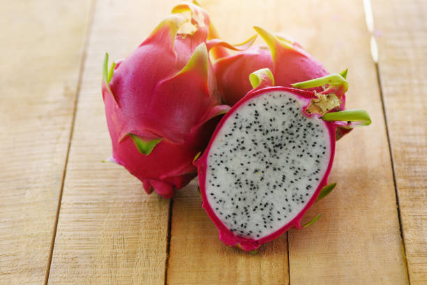 istock Dragon fruit slice on wooden background - Fresh pitaya summer tropical fruit concept 1167474000