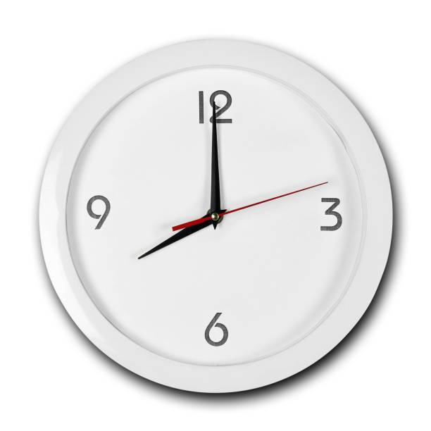 istock Large round white wall clock with white frame. The hands point to 8 o'clock. Close up. Isolated on white background 1167478350