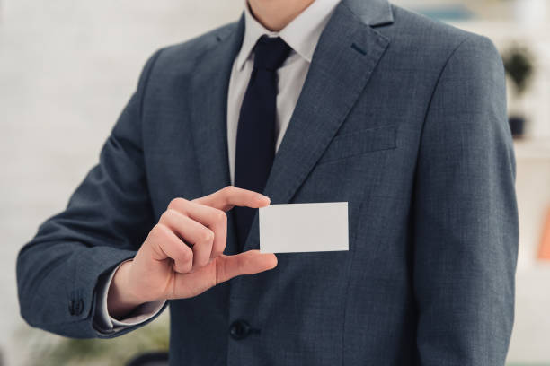 istock partial view of businessman presenting at camera white empty business card 1167481096
