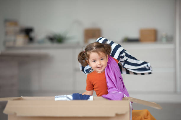 istock Little girl surrounded by clothes 1167486465