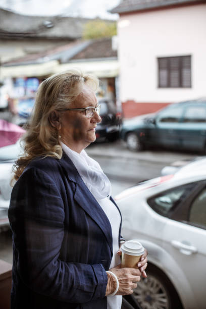 istock Senior woman with coffee to go 1167487712