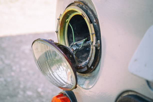 istock Broken car headlight hanging on the wires 1167487934