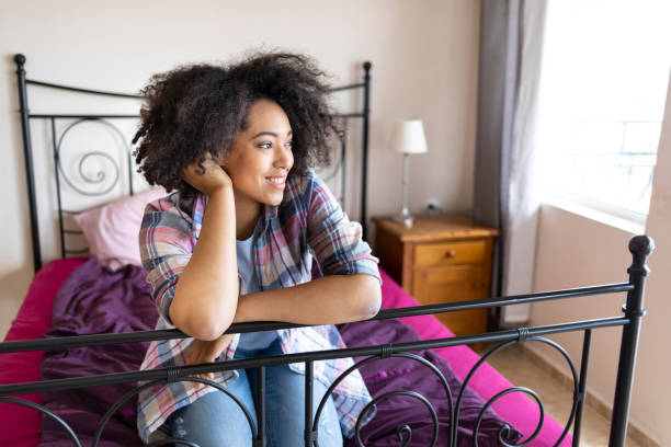 istock Beautiful african woman on bed 1167489771