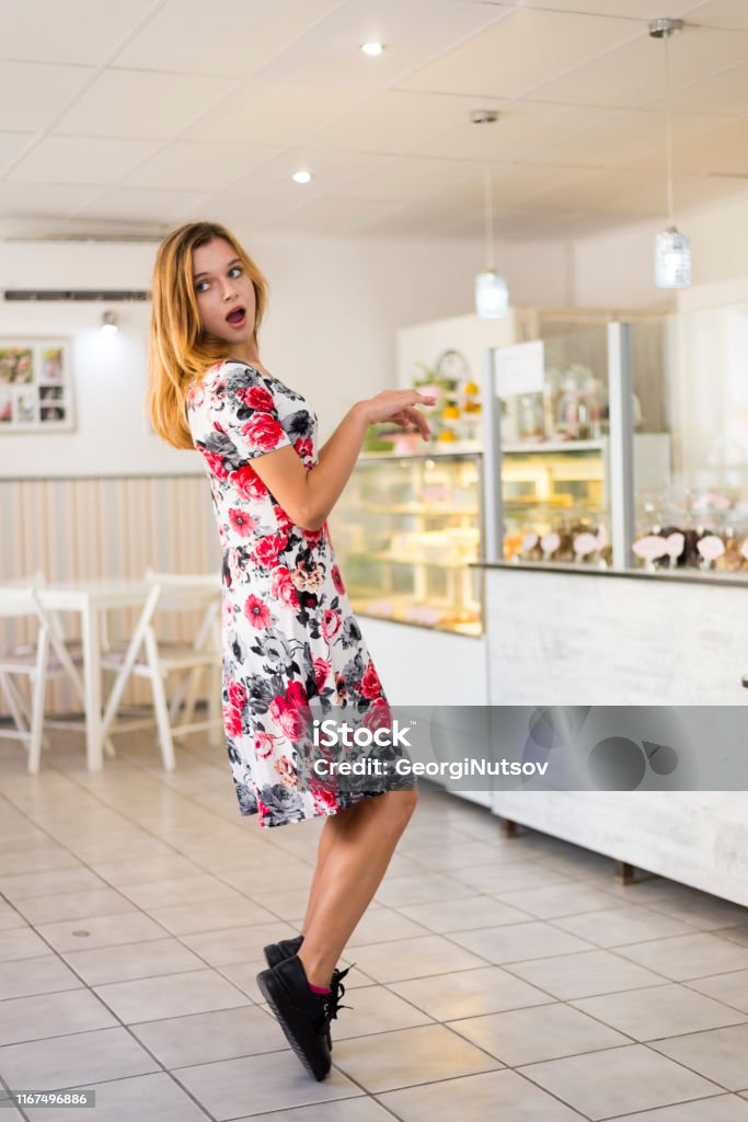 Happy young woman in a pastry shop. Business Stock Photo