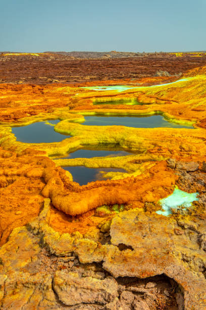 Dallol, Ethiopia. Danakil Depression Beautiful small sulfur lakes Dallol, Ethiopia. Danakil Depression is the hottest place on Earth in terms of year-round average temperatures. It is also one of the lowest places on the planet danakil depression stock pictures, royalty-free photos & images