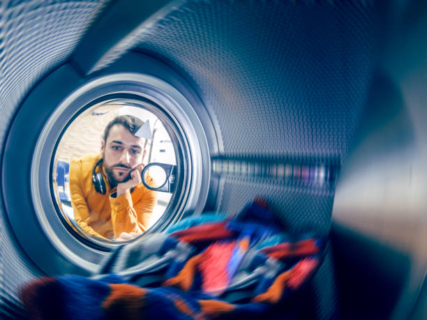 istock Young man washing his clothes 1167498188