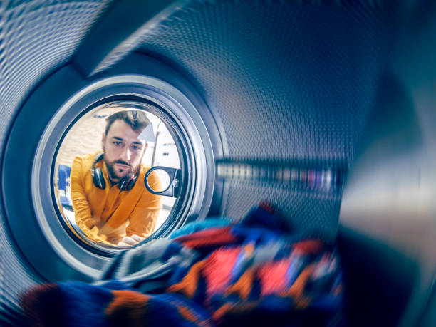 istock Young man washing his clothes 1167498244