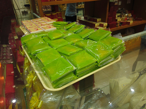 Bánh cốm is a Vietnamese dessert made from rice and mung bean. It is made by wrapping pounded and then green-coloured glutinous rice around sugary green-bean paste