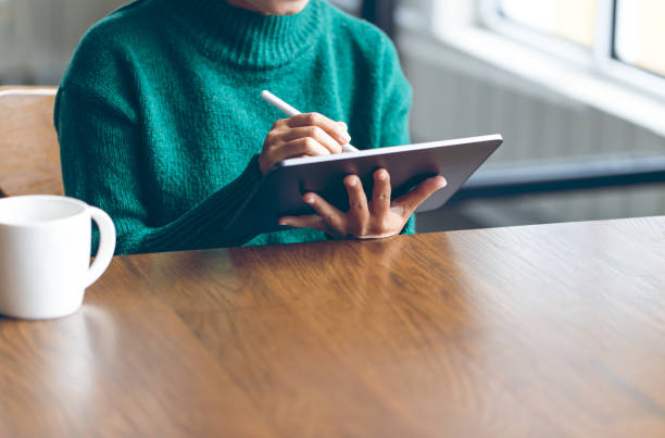 istock Asian women using digital tablet in office to operate the network, e commerce online at the office, The media reaches the operational guidelines, for panoramic banner background with copy space 1167498575