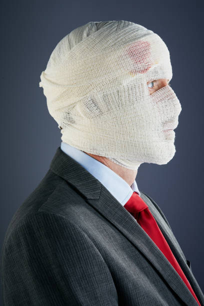 istock Businessman, head completely obscured and wrapped in bandages 1167498593