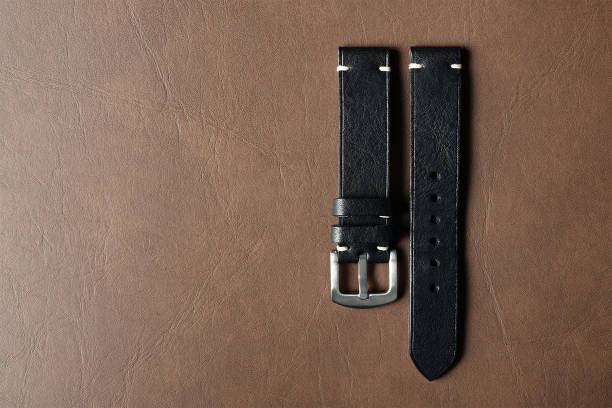 istock Black leather watch strap with stainless buckle on leather background, Craft and handmade watch bracelet, Luxury classic and vintage style. 1167499731