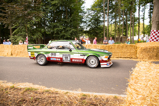 Jüchen, Germany - August 2019. A 1975 BMW 3.0 CSL on the race tracks around Schloss Dyck castle during the Classic Days in Jüchen, Germany.