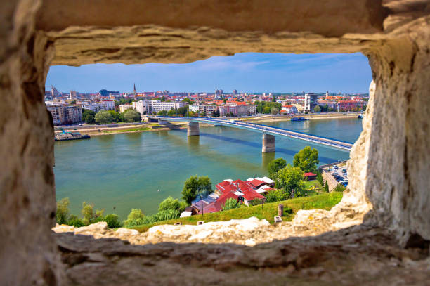 City Of Novi Sad and Danube river aerial view through stone window from Petrovaradin City Of Novi Sad and Danube river aerial view through stone window from Petrovaradin, Vojvodina region of Serbia Petrovaradin stock pictures, royalty-free photos & images