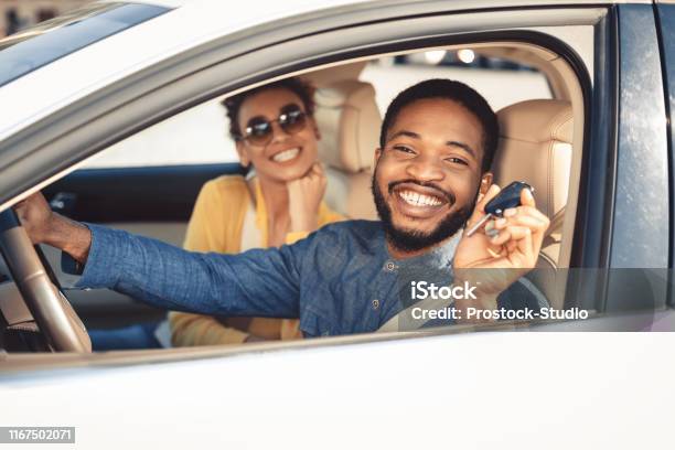 Visiting Car Dealership Afro Couple Showing Car Key Stock Photo - Download Image Now