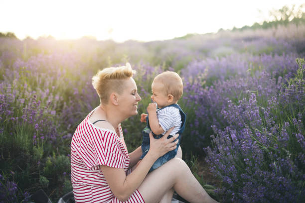 istock Happy mother with little son playing on lavender field 1167503617