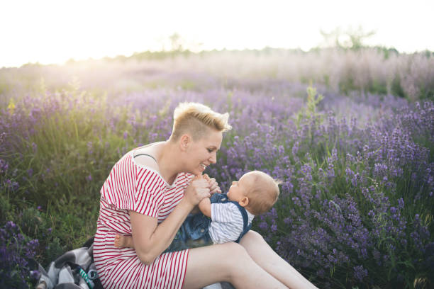istock Happy mother with little son playing on lavender field 1167504033