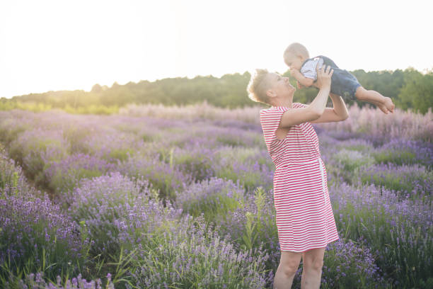 istock Happy mother with little son playing on lavender field 1167504131