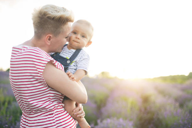 istock Happy mother with little son playing on lavender field 1167504242