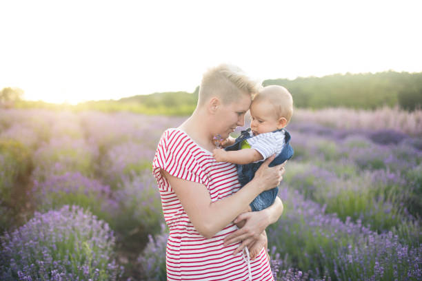 istock Happy mother with little son playing on lavender field 1167504441