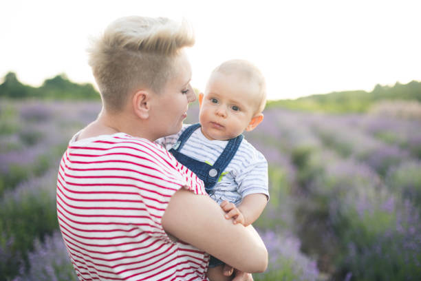istock Happy mother with little son playing on lavender field 1167504516