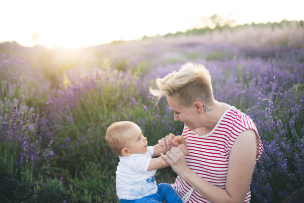 istock Happy mother with little son playing on lavender field 1167504576