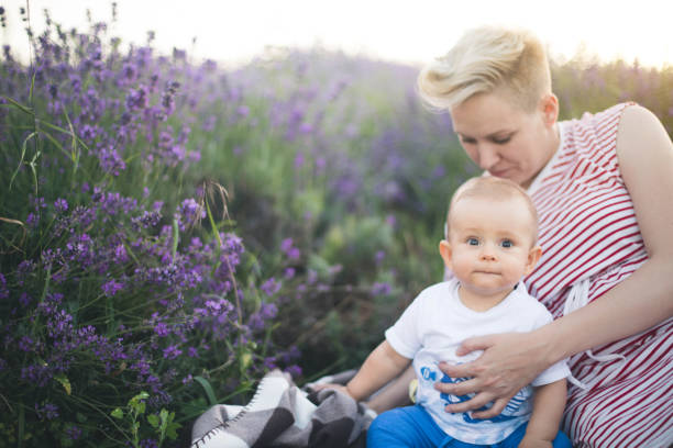 istock Happy mother with little son playing on lavender field 1167504664