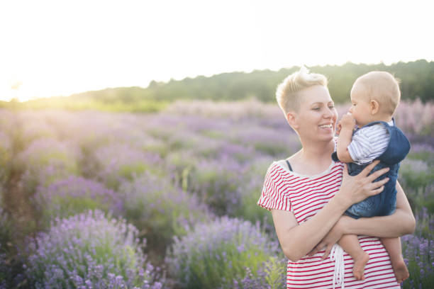 istock Happy mother with little son playing on lavender field 1167504714
