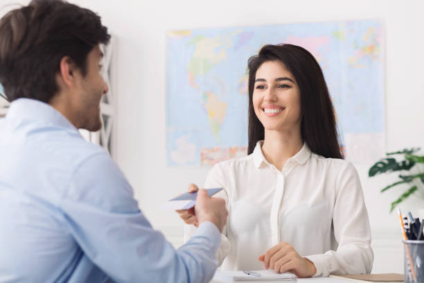 istock Tour agent giving passport with visa to man 1167505704