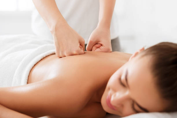 istock Professional therapist doing back massage to woman 1167505754