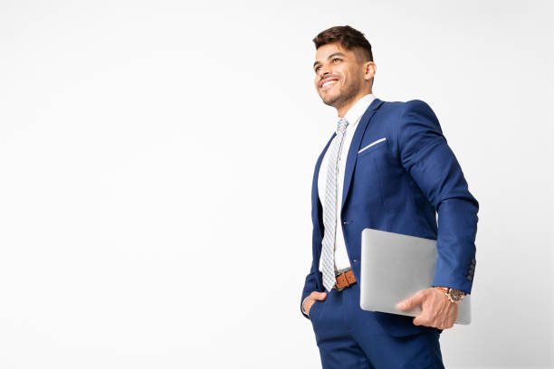 successful hispanic business man holding laptop on white studio background - necktie isolated clothing white imagens e fotografias de stock